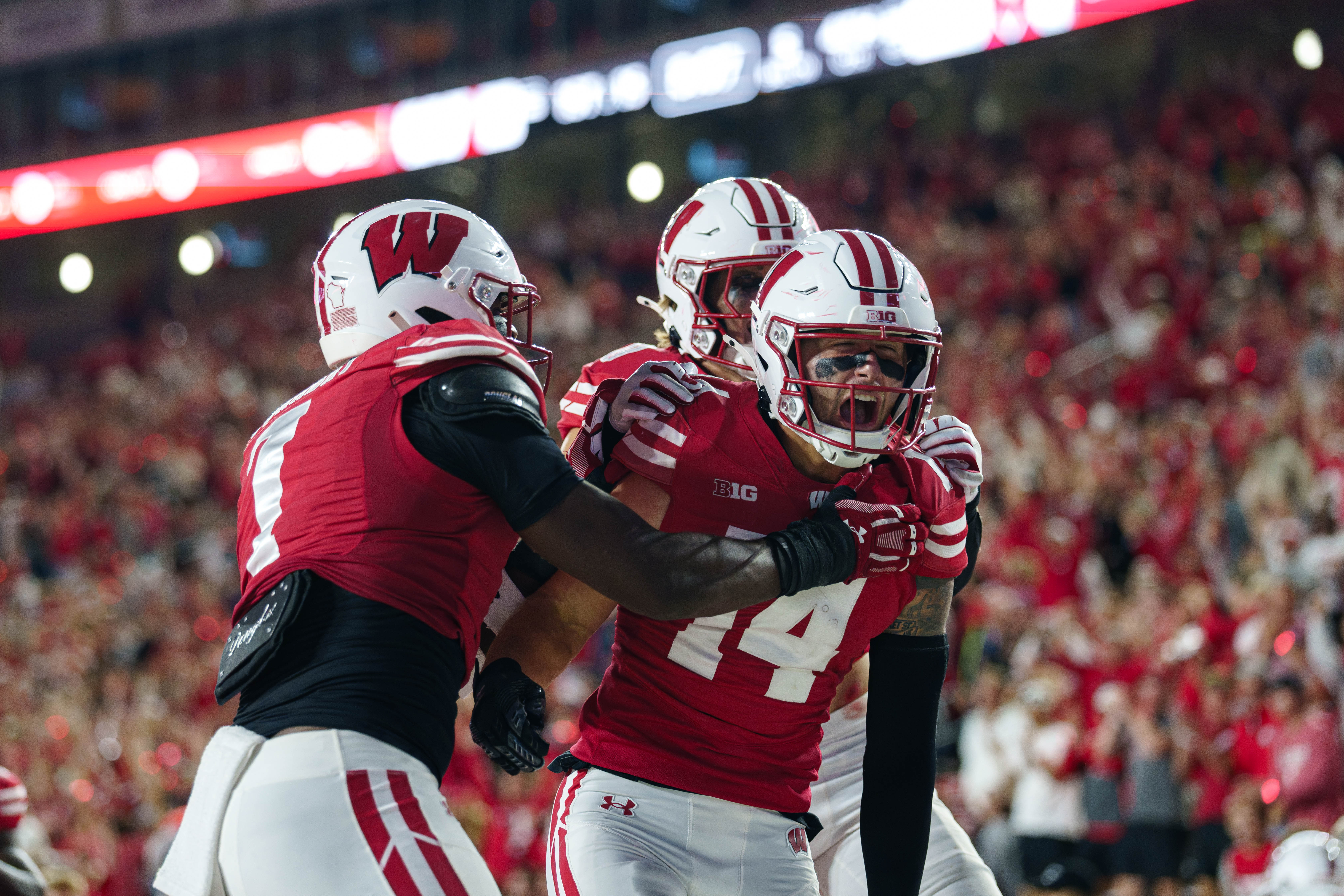 Wisconsin Badgers safety Preston Zachman (14) celebrates a touchdown that was called back with teammates against the Miami (OH) RedHawks at Camp Randall on August 28, 2025 in Madison, Wisconsin. Photography by Ross Harried for Second Crop Sports.