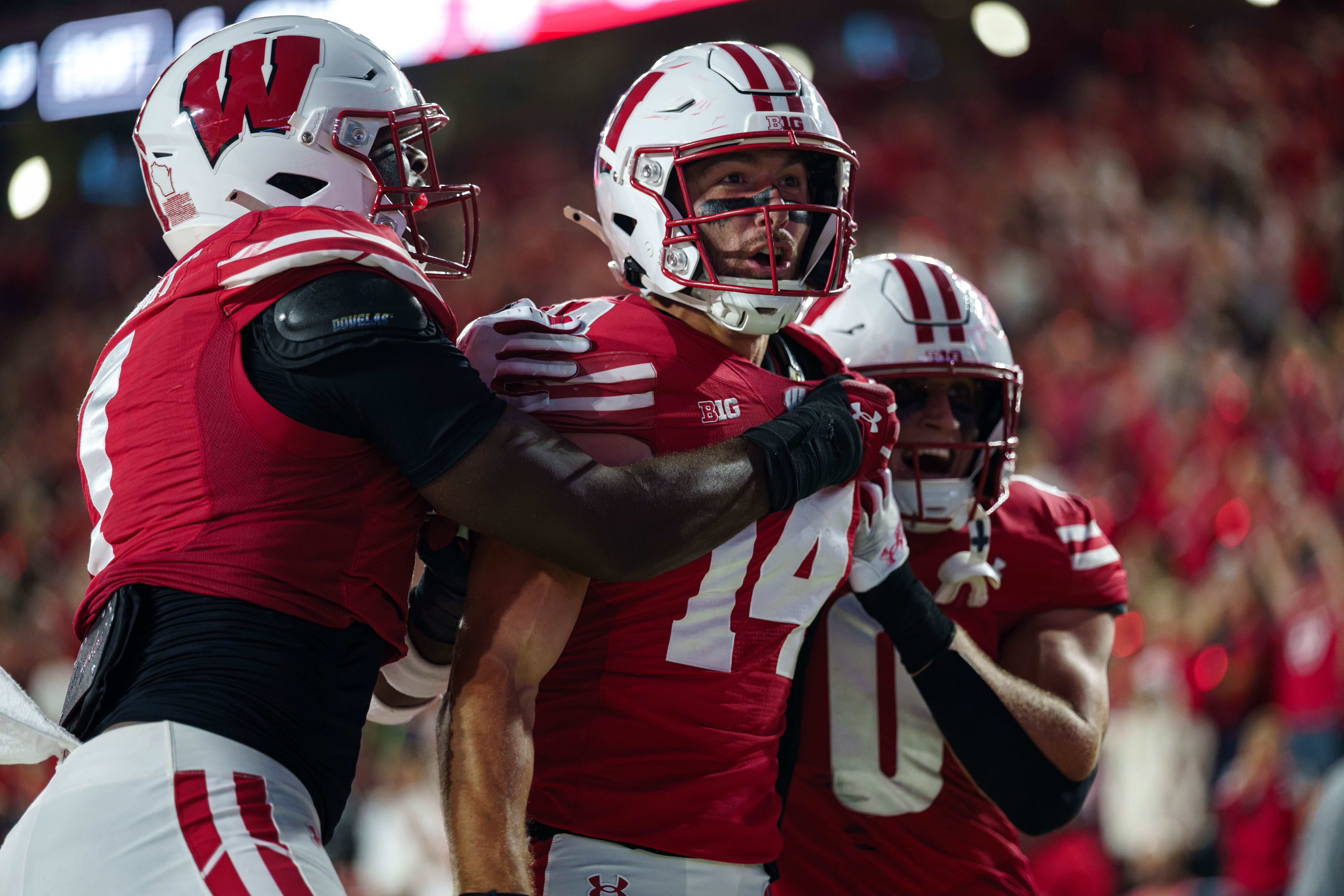 Wisconsin Badgers safety Preston Zachman (14) celebrates a touchdown that was called back with teammates against the Miami (OH) RedHawks at Camp Randall on August 28, 2025 in Madison, Wisconsin. Photography by Ross Harried for Second Crop Sports.