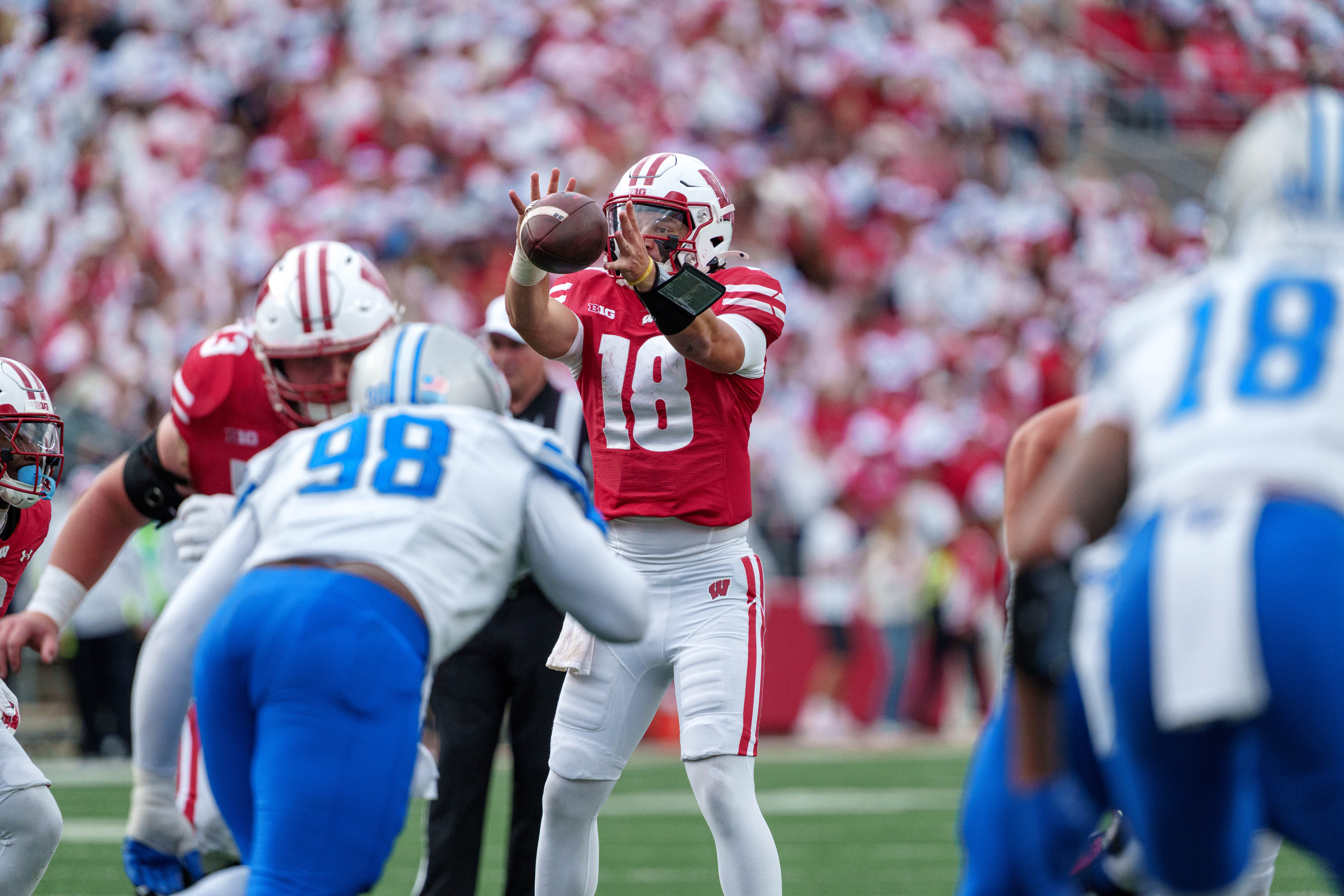 Sept 6, 2025; Madison, Wisconsin, USA; Wisconsin Badgers quarterback Danny O'Neil (18) takes a snap durning a college football game between the Wisconsin Badgers and the Middle Tennessee Blue Raiders at Camp Randall Stadium on September 06, 2025 in Madison, Wisconsin. Photography by Ross Harried for Second Crop Sports.