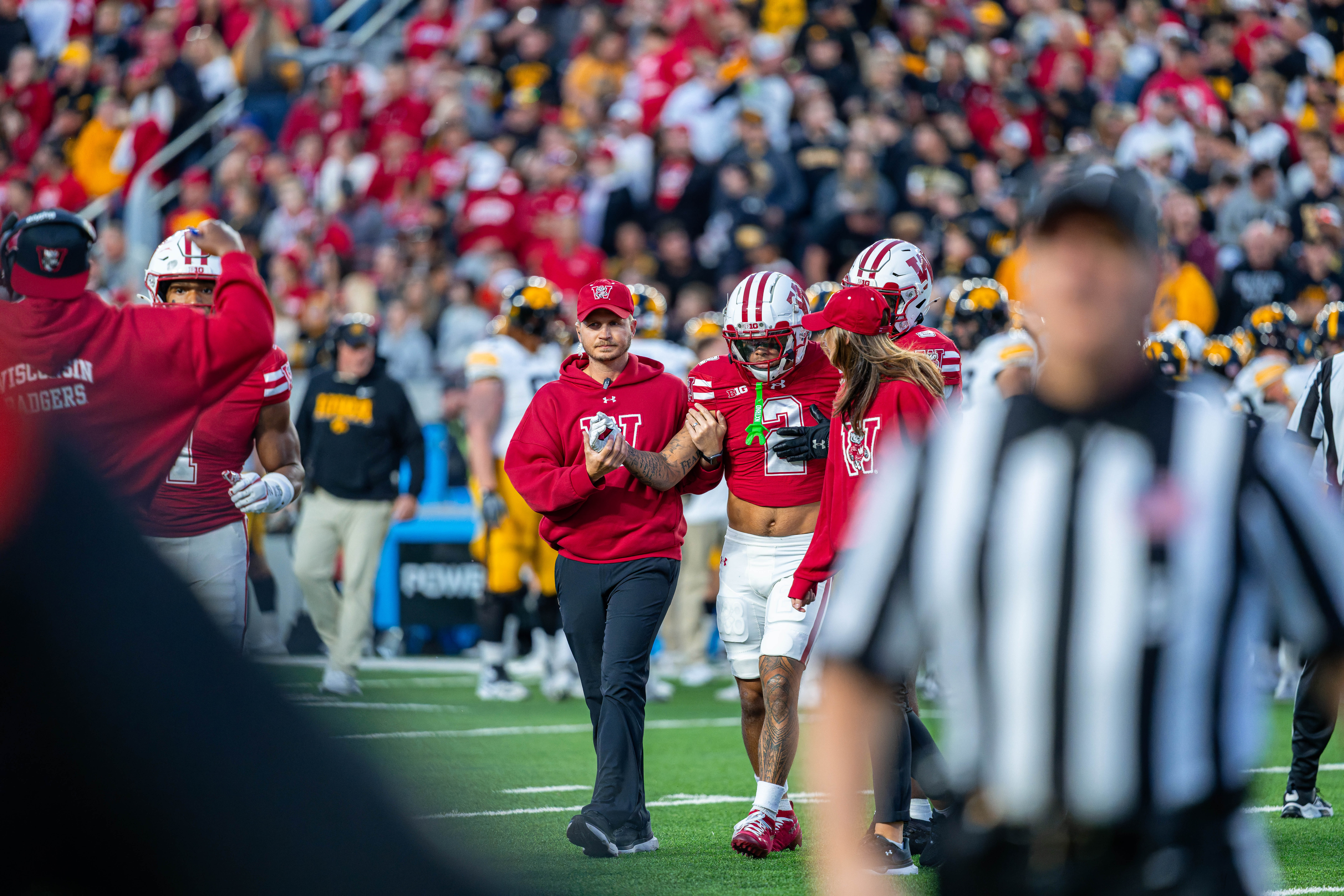 Oct 11, 2025; Madison, Wisconsin, USA; Wisconsin Badgers wide receiver Trech Kekahuna (2) is helped to the sidelines after an apparent injury in the first quarter against the Iowa Hawkeyes at Camp Randall Stadium. Mandatory Credit Photography by Ross Harried for Second Crop Sports.