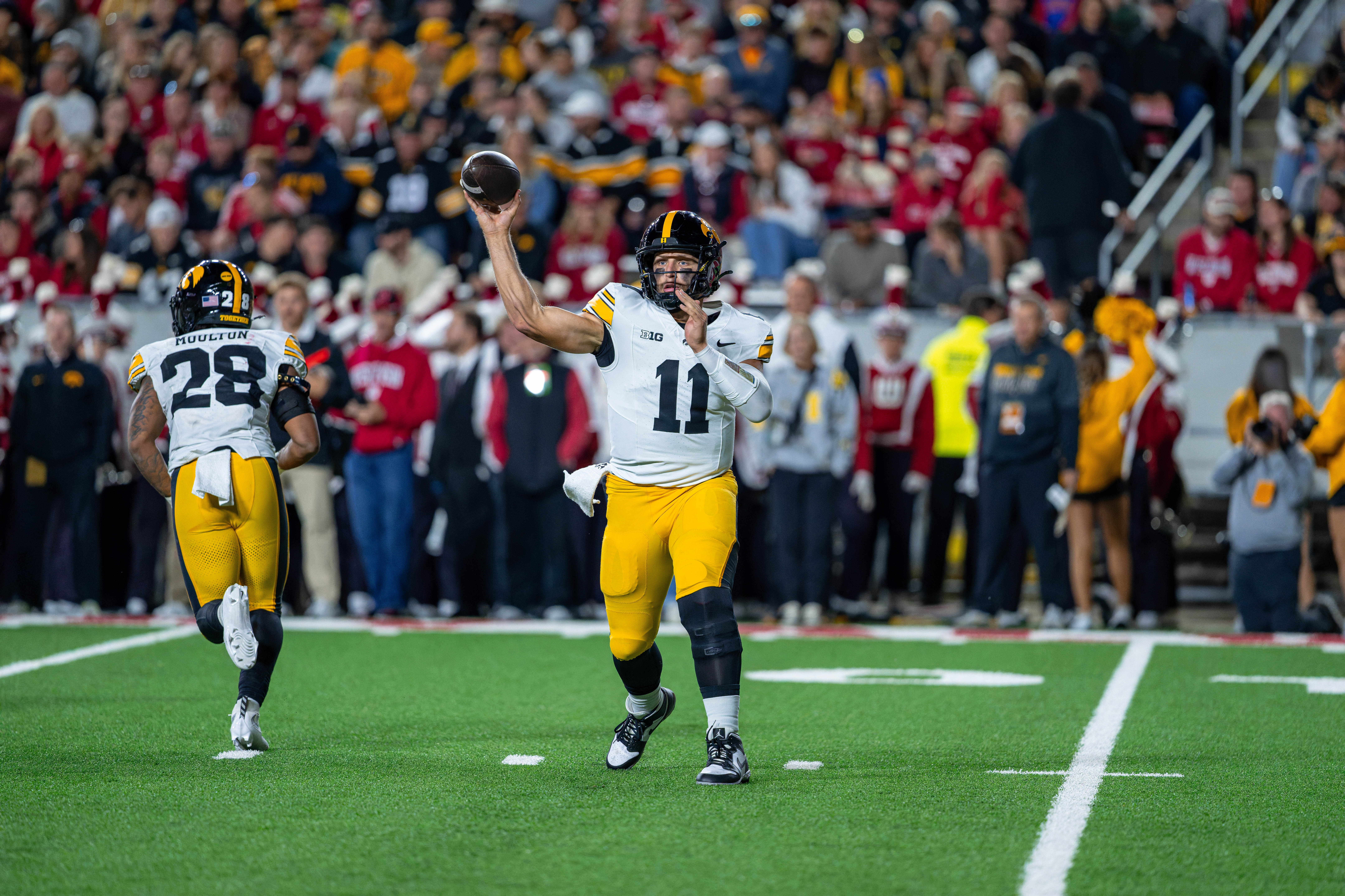Oct 11, 2025; Madison, Wisconsin, USA; Iowa Hawkeyes quarterback Mark Gronowski (11) attempts a pass in the first half against the Wisconsin Badgers at Camp Randall Stadium. Mandatory Credit Photography by Ross Harried for Second Crop Sports.