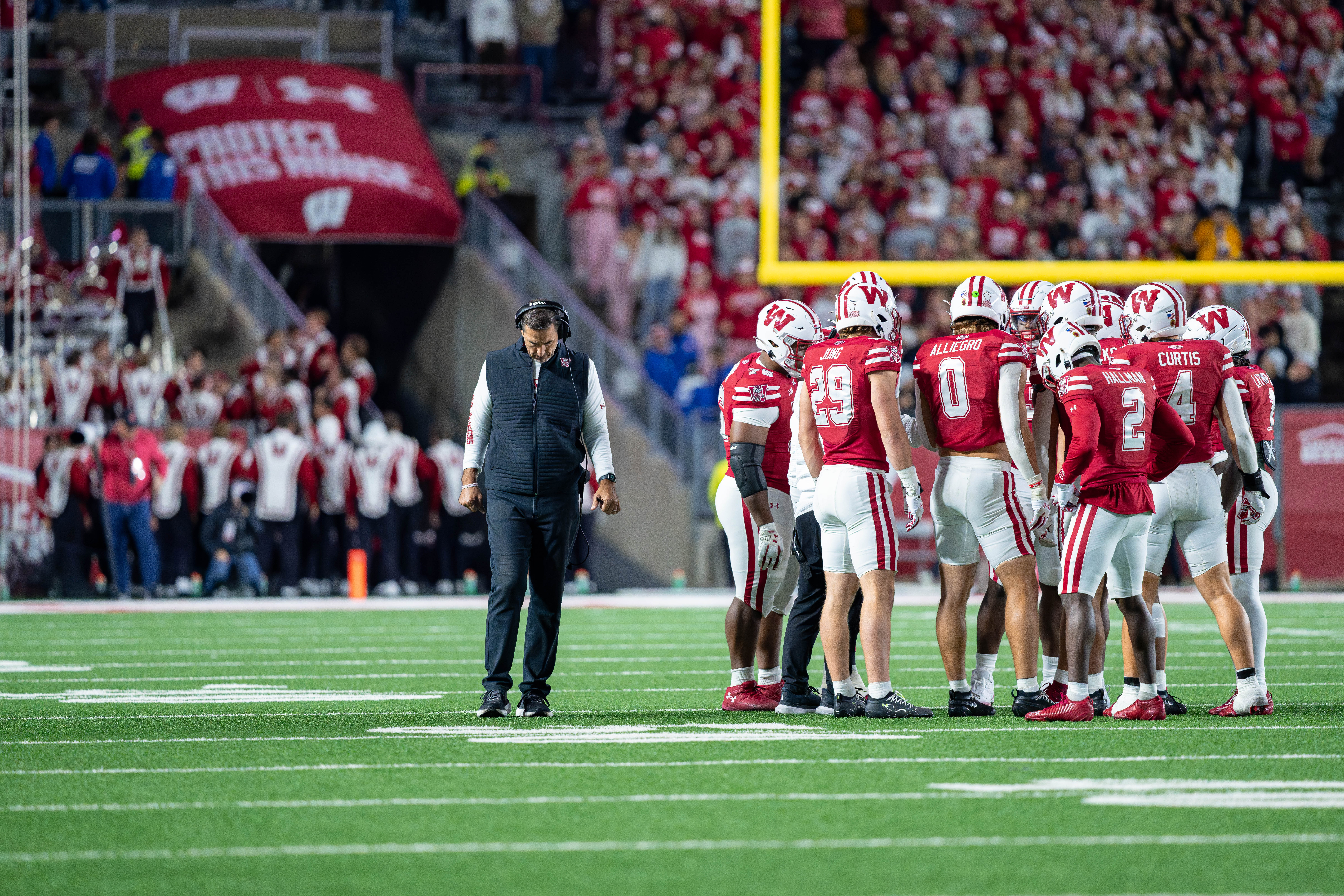 Oct 11, 2025; Madison, Wisconsin, USA; Wisconsin Badgers head coach Luke Fickell and his team take a timeout in the second half against the Iowa Hawkeyes at Camp Randall Stadium. Mandatory Credit Photography by Ross Harried for Second Crop Sports.