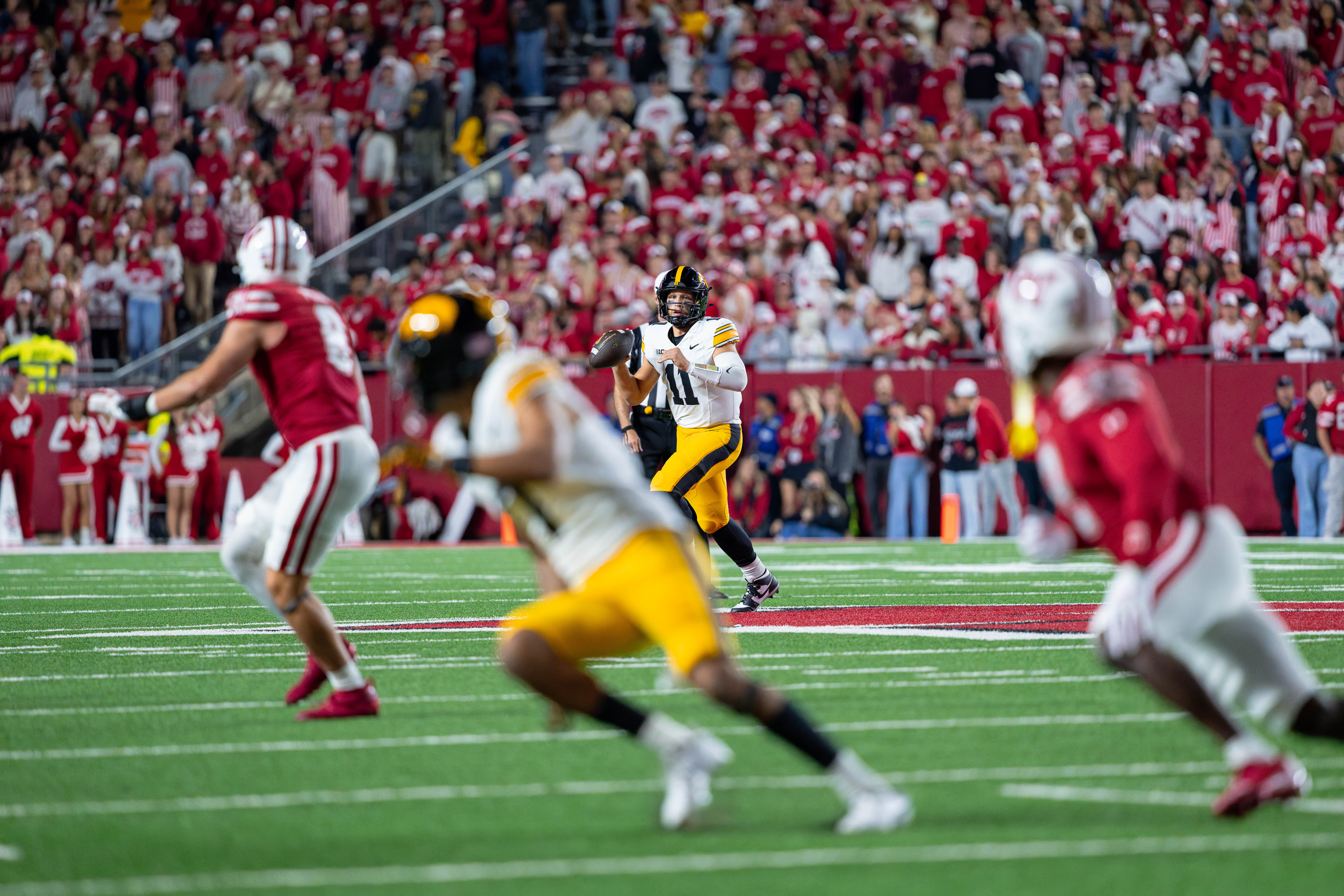 Oct 11, 2025; Madison, Wisconsin, USA; Iowa Hawkeyes quarterback Mark Gronowski (11) looks down field to pass in the second half against the Wisconsin Badgers at Camp Randall Stadium. Mandatory Credit Photography by Ross Harried for Second Crop Sports.
