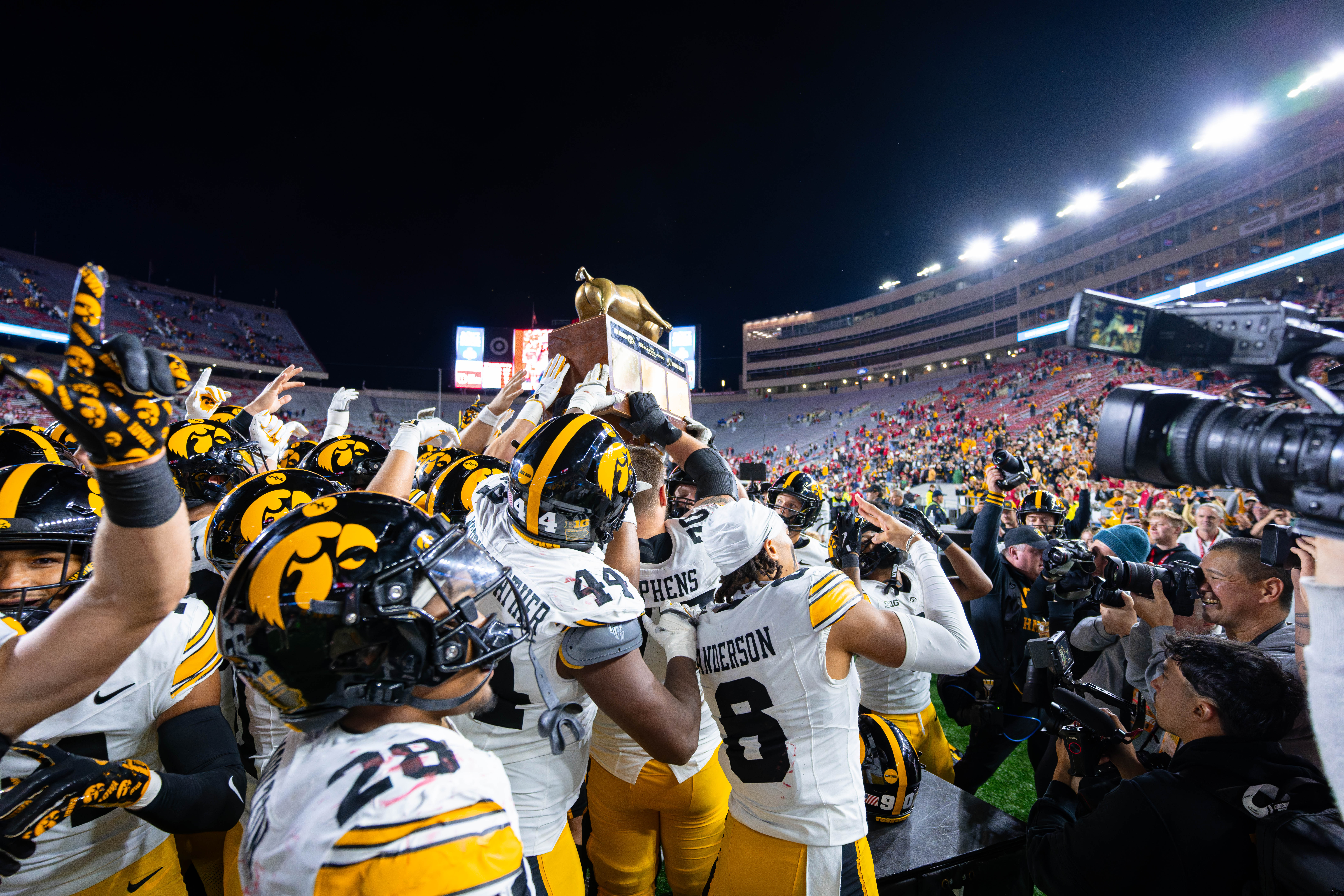 Oct 11, 2025; Madison, Wisconsin, USA; The Iowa Hawkeyes celebrate a win against the Wisconsin Badgers with the Heartland Trophy at Camp Randall Stadium. Mandatory Credit Photography by Ross Harried for Second Crop Sports.