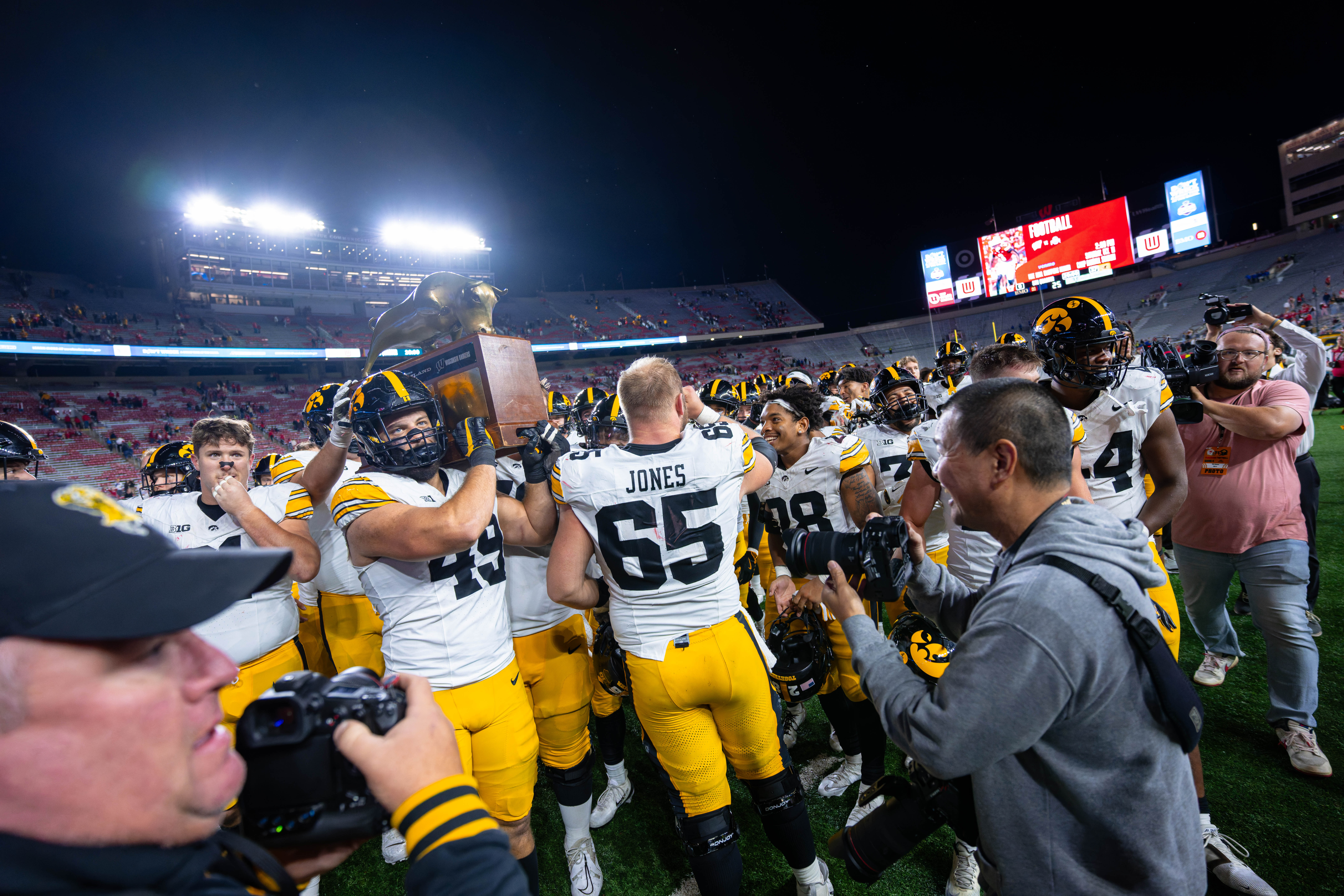 Oct 11, 2025; Madison, Wisconsin, USA; The Iowa Hawkeyes celebrate a win against the Wisconsin Badgers with the Heartland Trophy at Camp Randall Stadium. Mandatory Credit Photography by Ross Harried for Second Crop Sports.