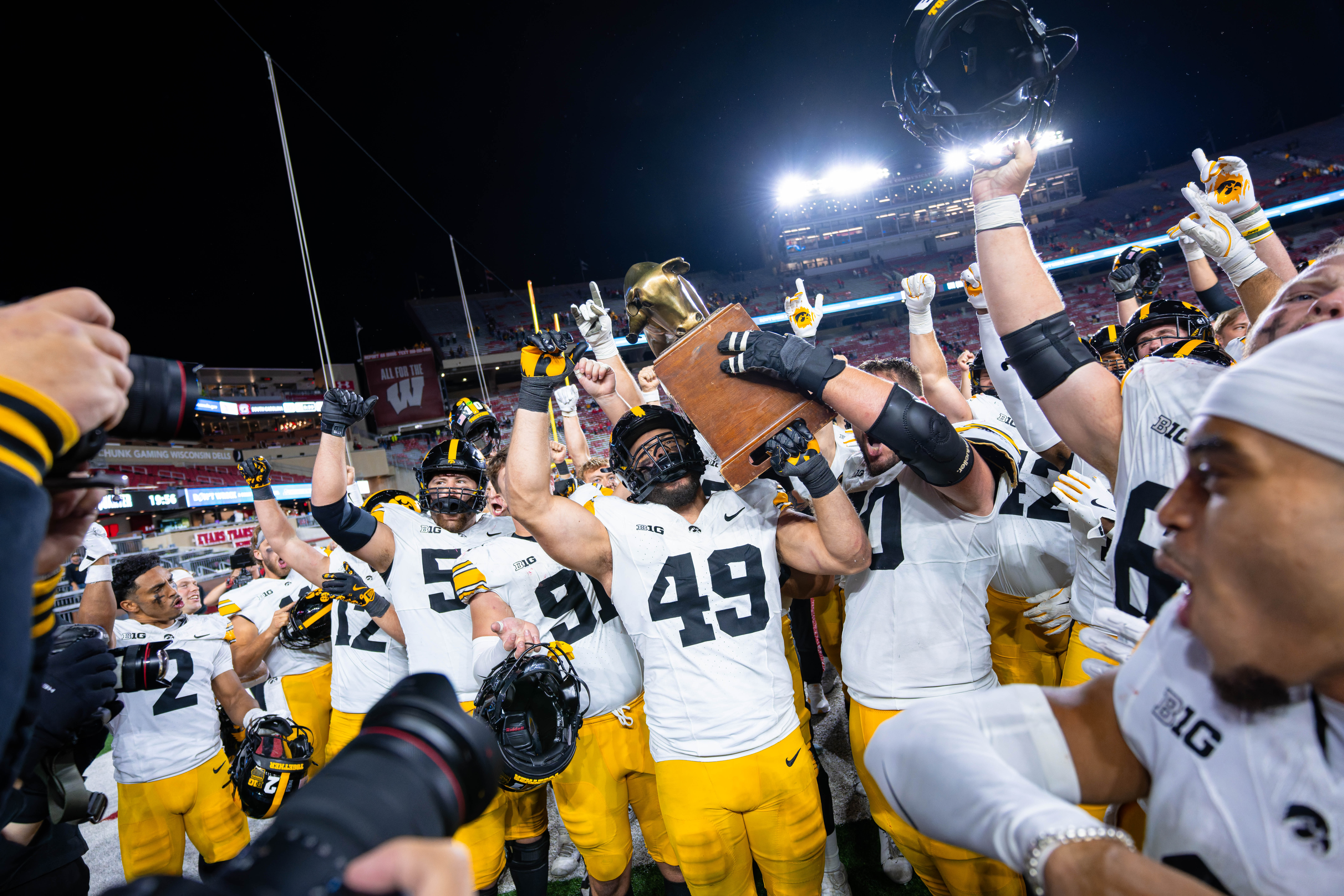 Oct 11, 2025; Madison, Wisconsin, USA; The Iowa Hawkeyes celebrate a win against the Wisconsin Badgers with the Heartland Trophy at Camp Randall Stadium. Mandatory Credit Photography by Ross Harried for Second Crop Sports.