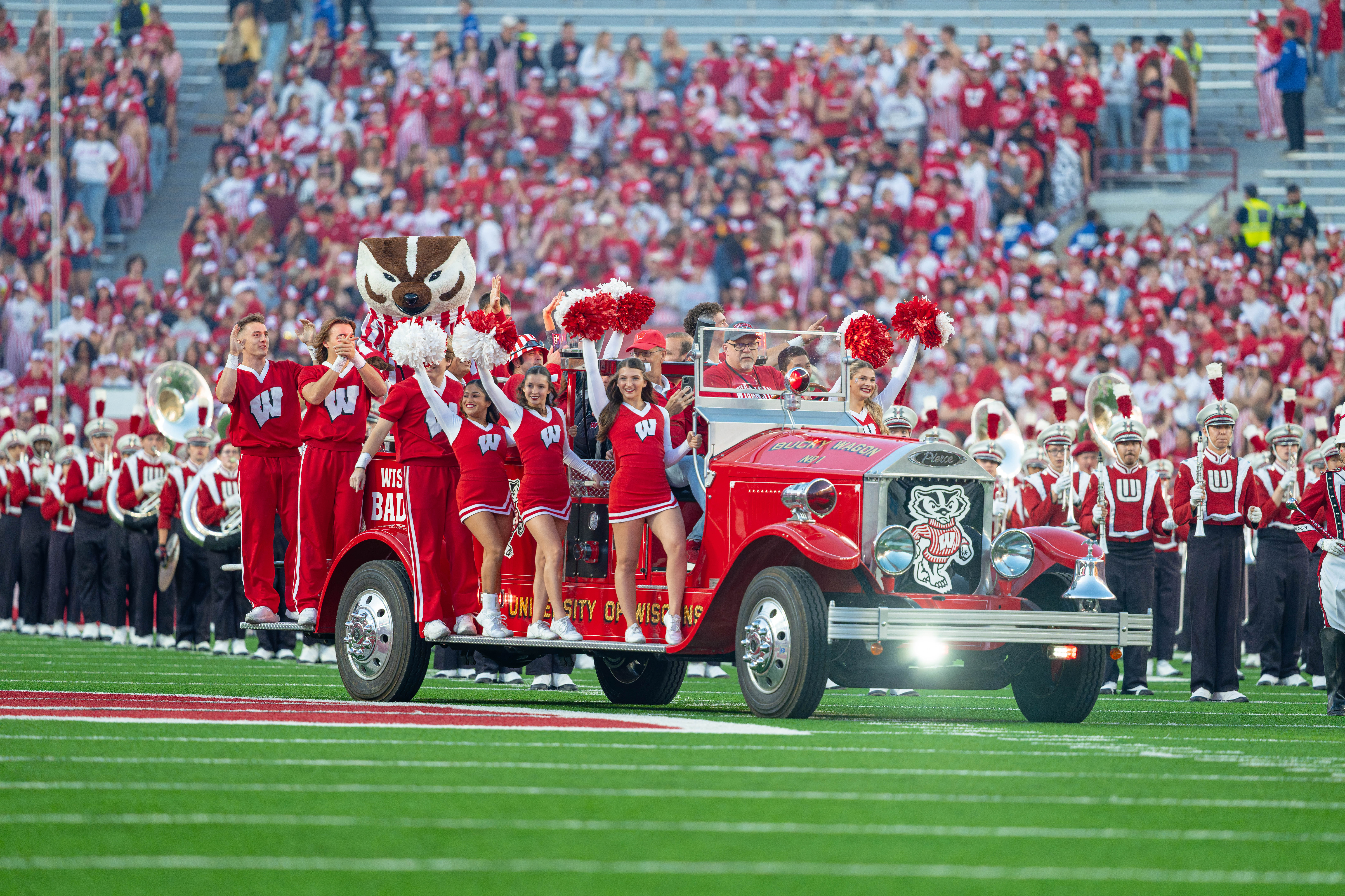 Oct 11, 2025; Madison, Wisconsin, USA; Bucky Badger and the Wisconsin Badger Cheerleaders take the field in the Bucky Wagon before a game against the Iowa Hawkeyes at Camp Randall Stadium. Mandatory Credit Photography by Ross Harried for Second Crop Sports.