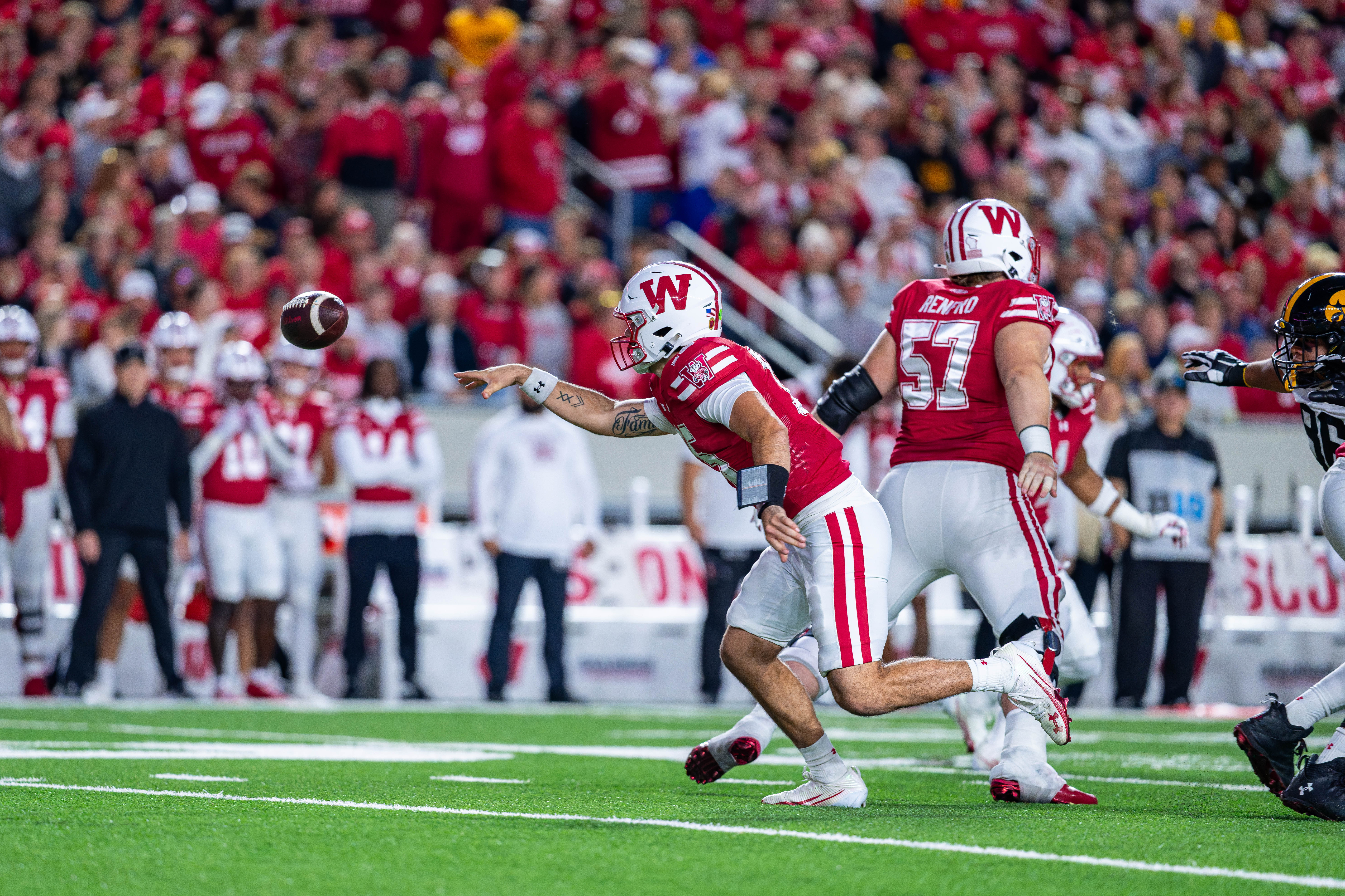 Oct 11, 2025; Madison, Wisconsin, USA; Wisconsin Badgers quarterback Hunter Simmons (15) pitches the ball in the first quarter against the Iowa Hawkeyes at Camp Randall Stadium. Mandatory Credit Photography by Ross Harried for Second Crop Sports.