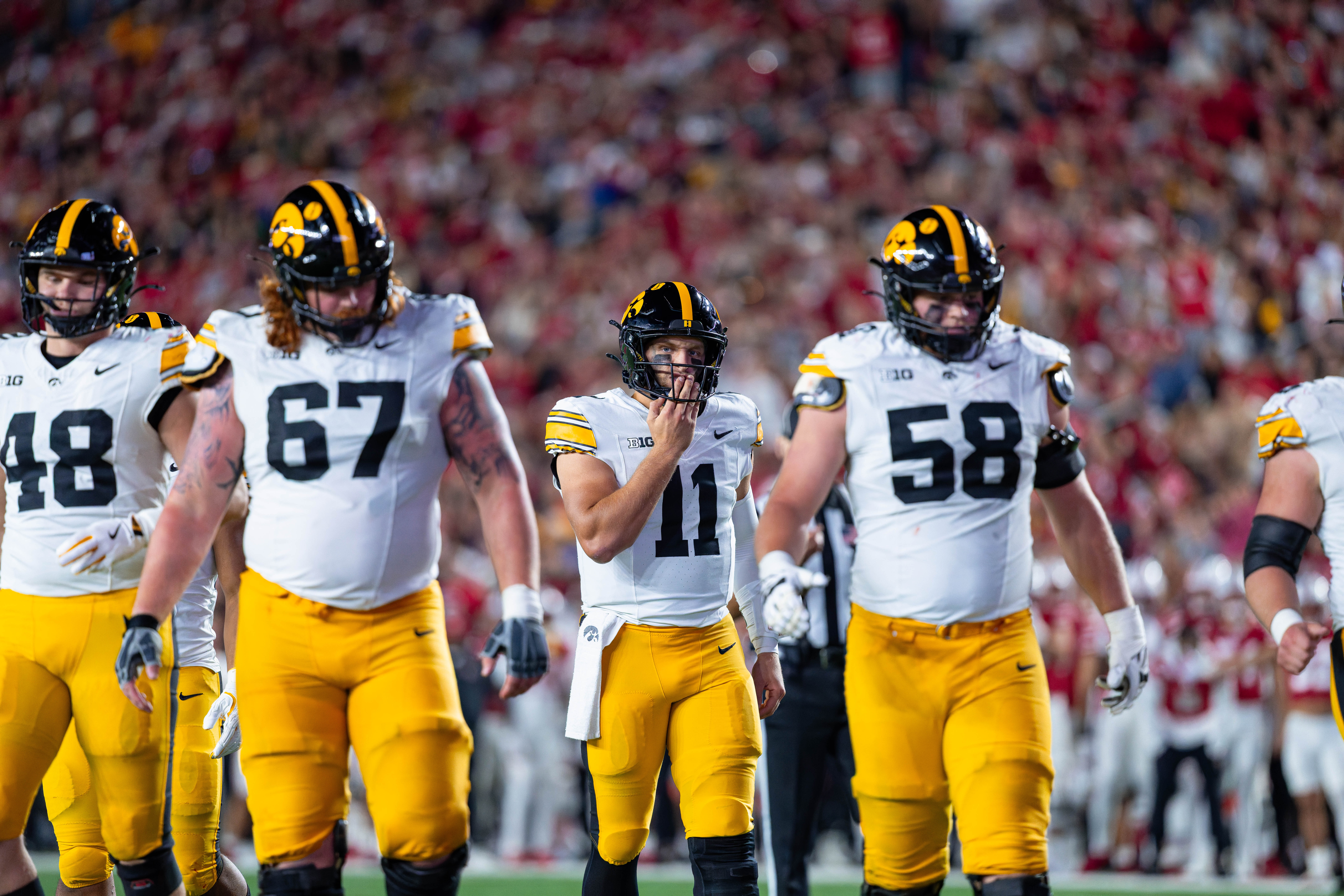 Oct 11, 2025; Madison, Wisconsin, USA; Iowa Hawkeyes quarterback Mark Gronowski (11) and the Iowa offense walk towards the line of scrimmage in the first half against the Wisconsin Badgers at Camp Randall Stadium. Mandatory Credit Photography by Ross Harried for Second Crop Sports.