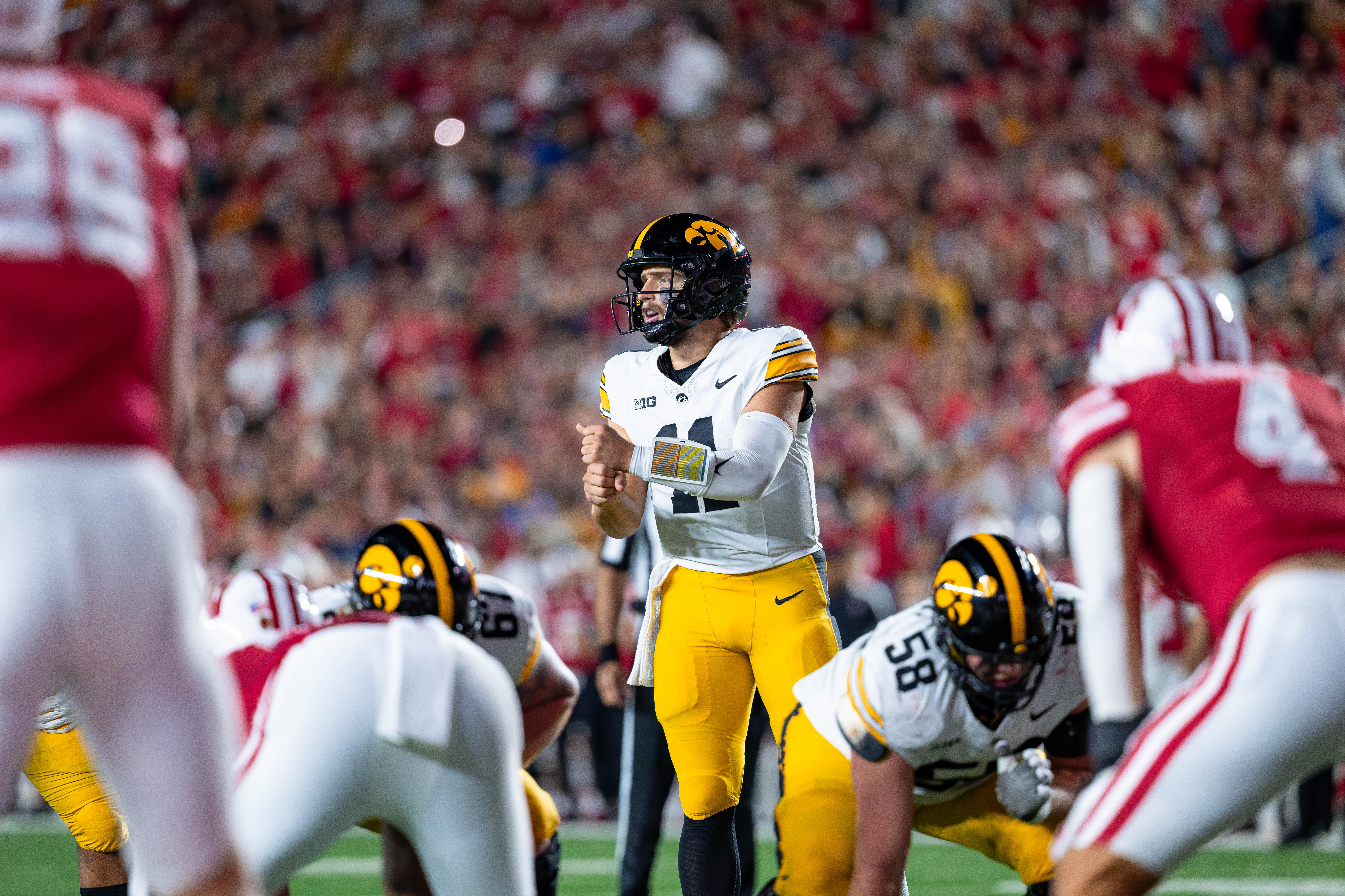 Oct 11, 2025; Madison, Wisconsin, USA; Iowa Hawkeyes quarterback Mark Gronowski (11) makes a hand signal before a play in the first half against the Wisconsin Badgers at Camp Randall Stadium. Mandatory Credit Photography by Ross Harried for Second Crop Sports.