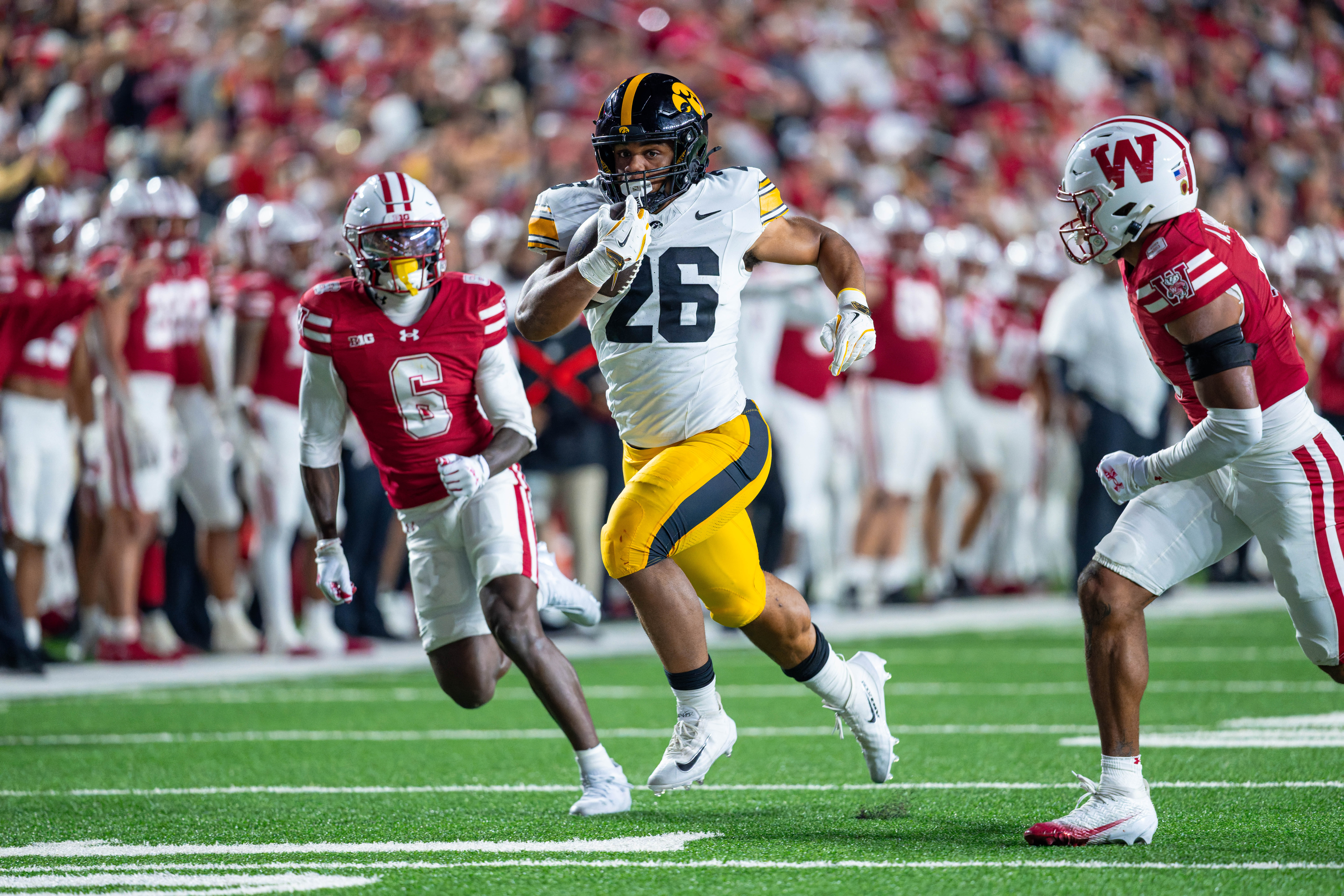 Oct 11, 2025; Madison, Wisconsin, USA; Iowa Hawkeyes running back Xavier Williams (26) runs the ball in the second half against the Wisconsin Badgers at Camp Randall Stadium. Mandatory Credit Photography by Ross Harried for Second Crop Sports.