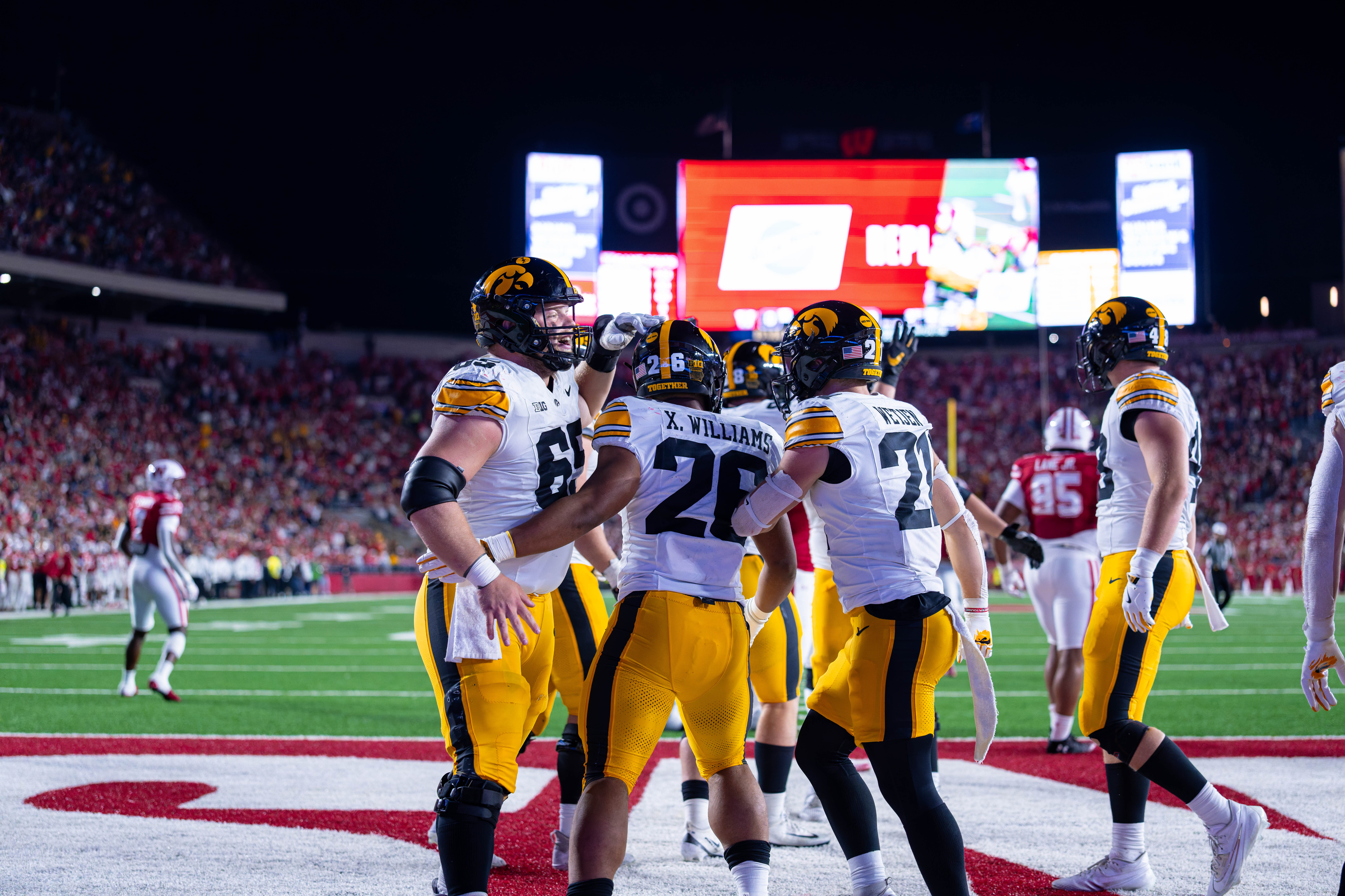 Oct 11, 2025; Madison, Wisconsin, USA; Iowa Hawkeyes running back Xavier Williams (26) celebrates a touchdown with his teammates in the second half against the Wisconsin Badgers at Camp Randall Stadium. Mandatory Credit Photography by Ross Harried for Second Crop Sports.