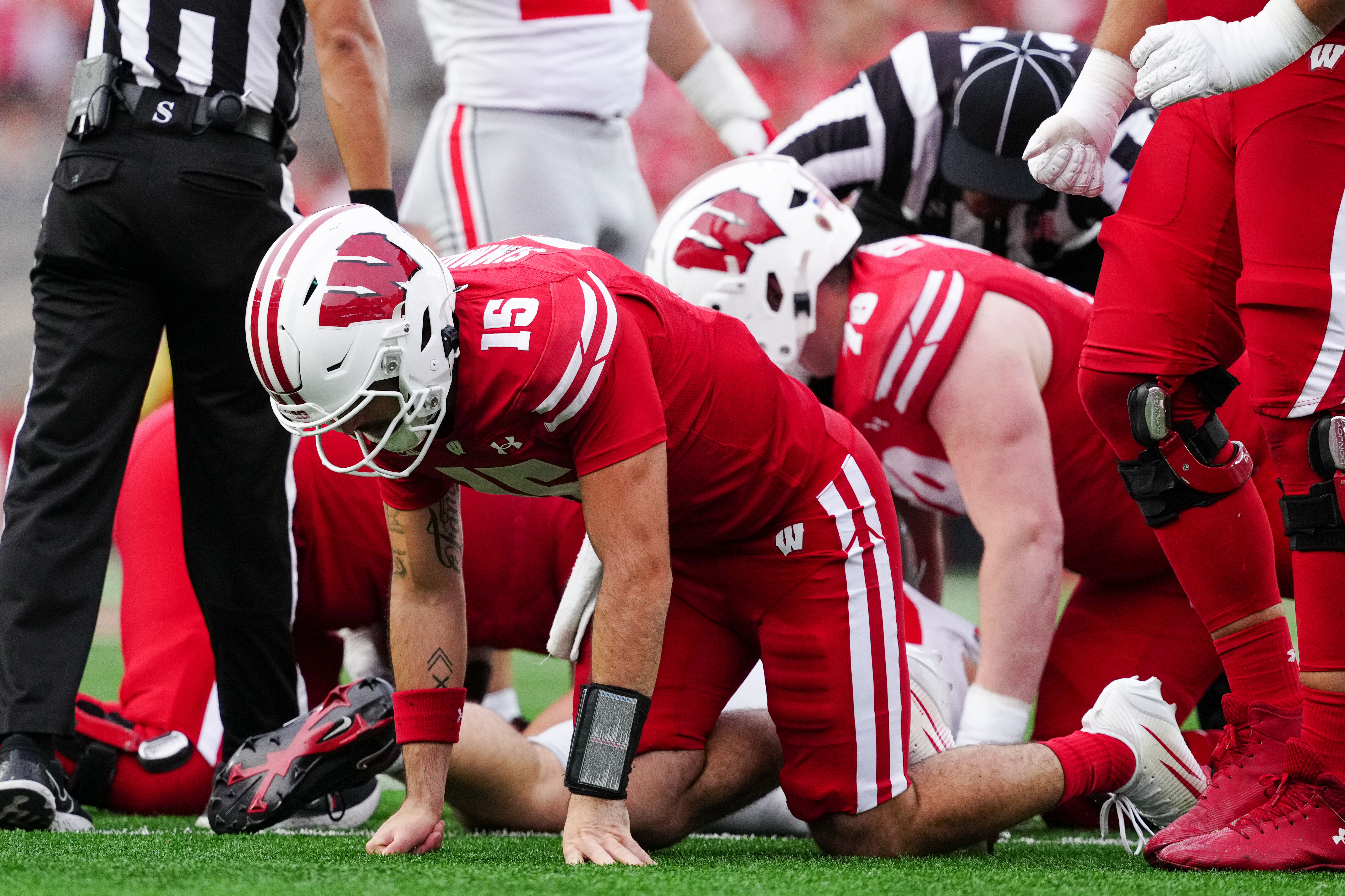 Oct 18, 2025; Madison, Wisconsin, USA; Wisconsin Badgers quarterback Hunter Simmons (15) is slow to get up after a play in the second half against the Ohio State Buckeyes at Camp Randall Stadium on October 18, 2025 in Madison, Wisconsin. Photography by Ross Harried for Second Crop Sports.