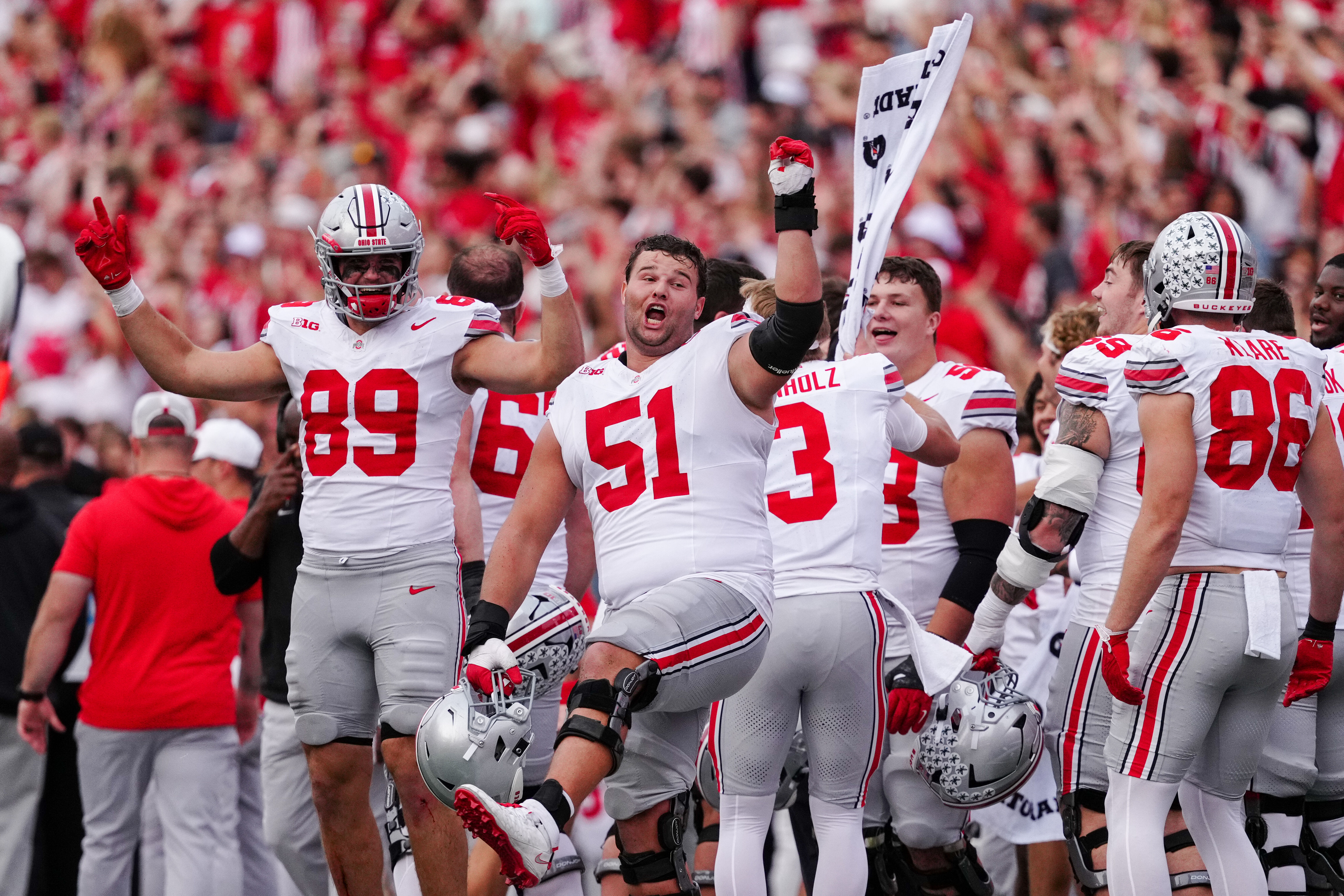 Oct 18, 2025; Madison, Wisconsin, USA; Ohio State Buckeyes tight end Will Kacmarek (89) and offensive lineman Luke Montgomery (51) participate in Jump Around at the end of the third quarter against the Wisconsin Badgers at Camp Randall Stadium on October 18, 2025 in Madison, Wisconsin. Photography by Ross Harried for Second Crop Sports.