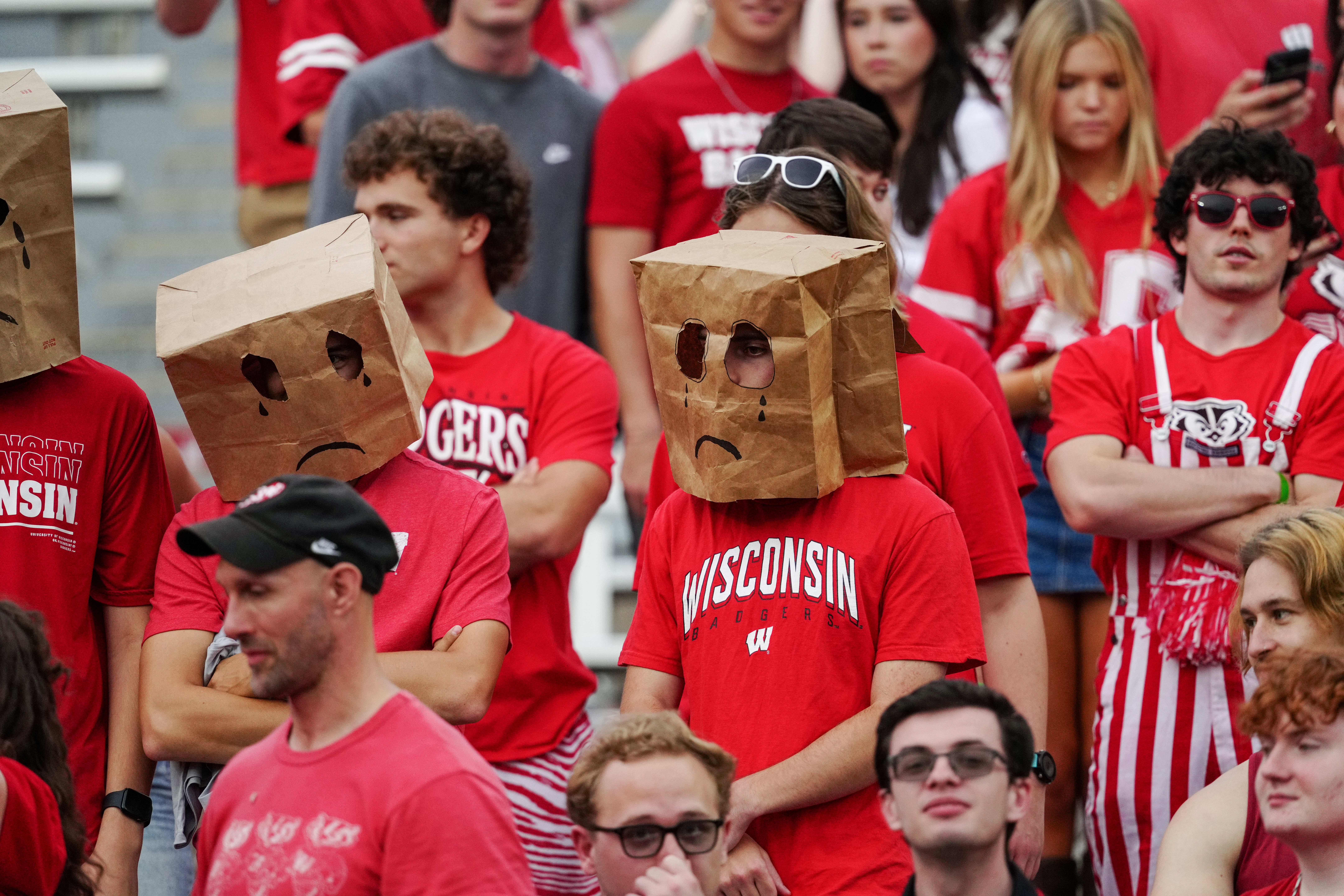 Oct 18, 2025; Madison, Wisconsin, USA; Wisconsin Badgers fans hide their faces in the second half against the Ohio State Buckeyes at Camp Randall Stadium on October 18, 2025 in Madison, Wisconsin. Photography by Ross Harried for Second Crop Sports.