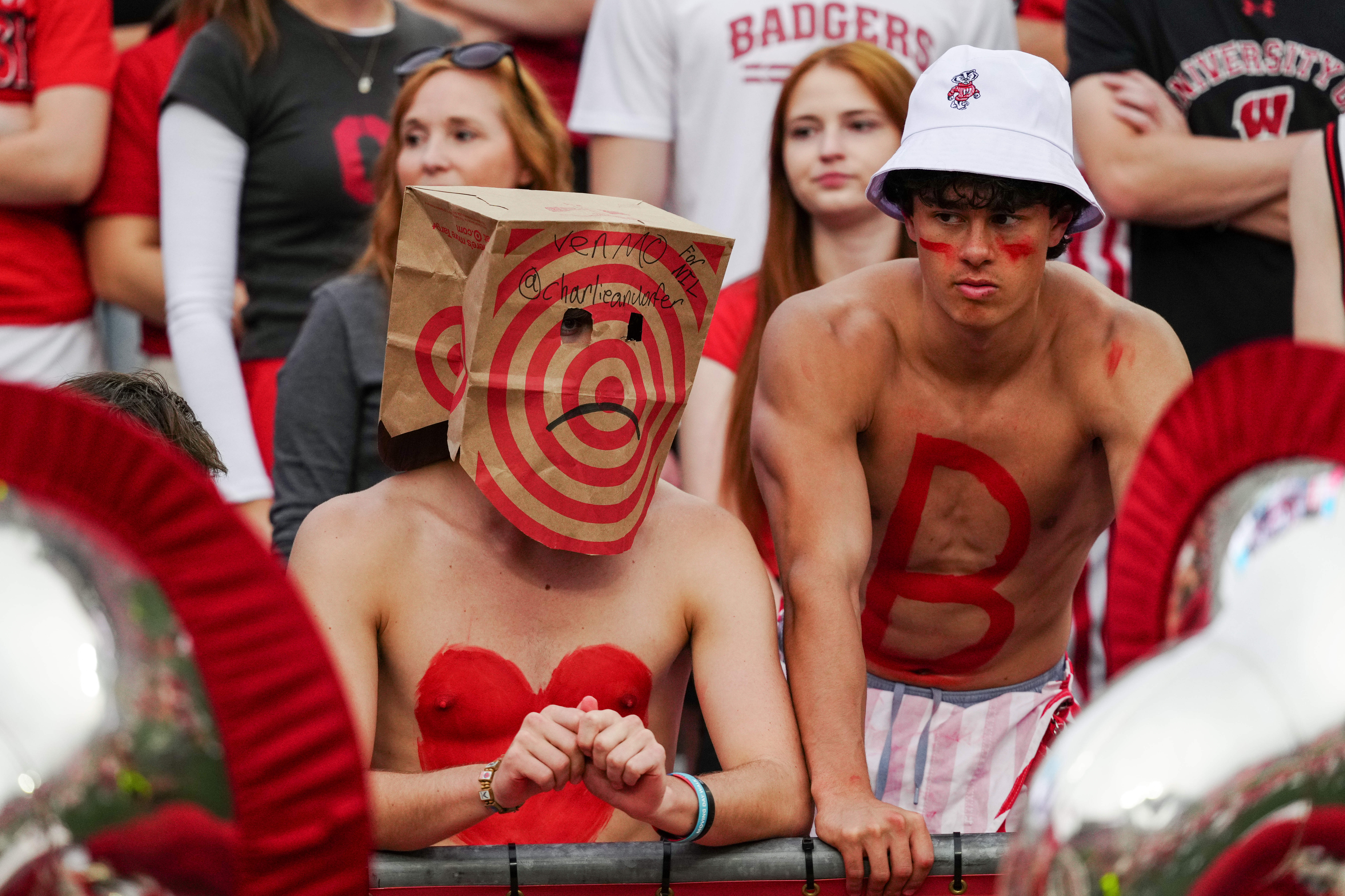 Oct 18, 2025; Madison, Wisconsin, USA; Wisconsin Badgers fans hide their faces in the second half against the Ohio State Buckeyes at Camp Randall Stadium on October 18, 2025 in Madison, Wisconsin. Photography by Ross Harried for Second Crop Sports.