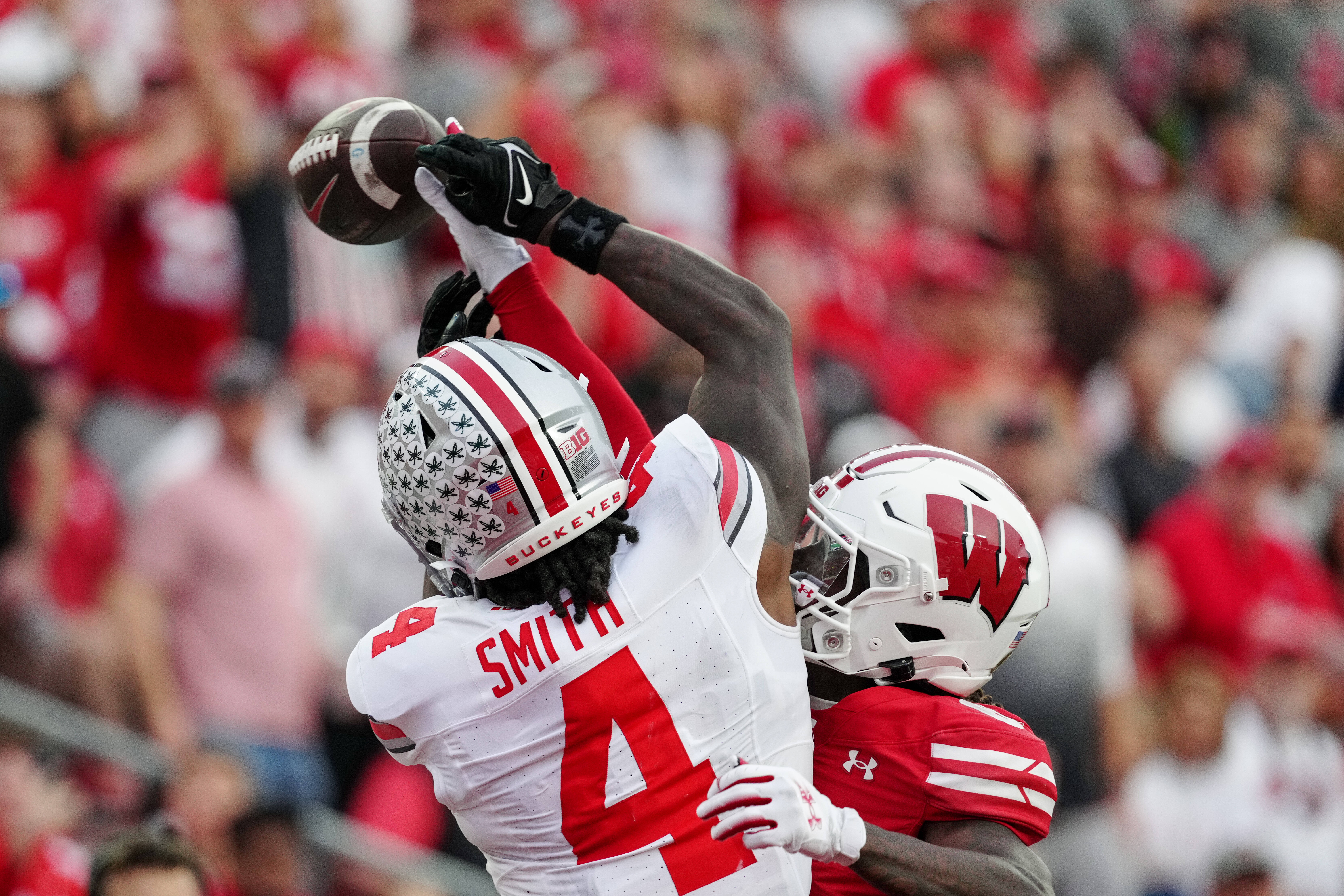 Oct 18, 2025; Madison, Wisconsin, USA; Wisconsin Badgers cornerback Omillio Agard (6) knocks down a pass to Ohio State Buckeyes wide receiver Jeremiah Smith (4) in the end zone during the second half at Camp Randall Stadium on October 18, 2025 in Madison, Wisconsin. Photography by Ross Harried for Second Crop Sports.