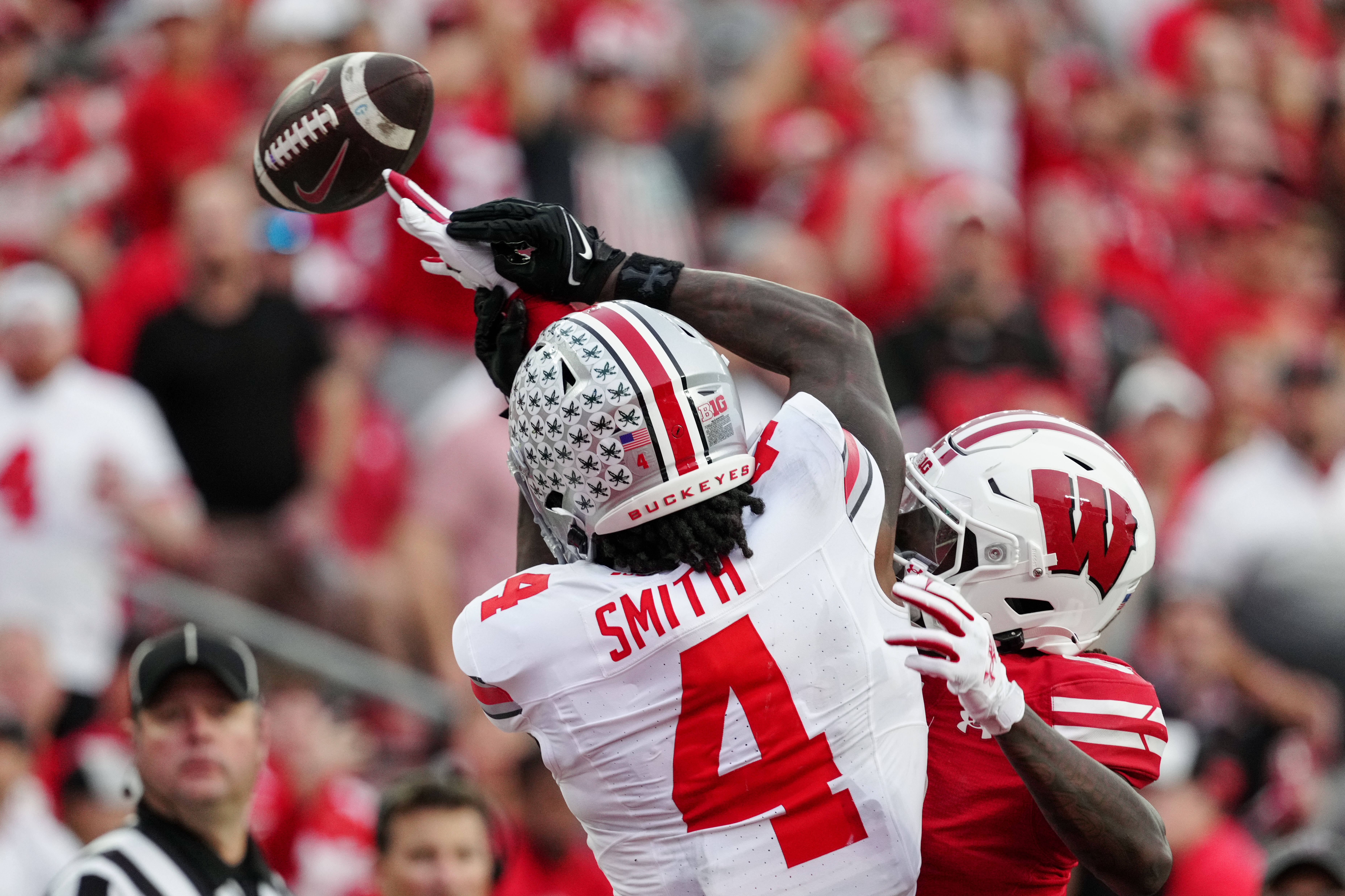 Oct 18, 2025; Madison, Wisconsin, USA; Wisconsin Badgers cornerback Omillio Agard (6) knocks down a pass to Ohio State Buckeyes wide receiver Jeremiah Smith (4) in the end zone during the second half at Camp Randall Stadium on October 18, 2025 in Madison, Wisconsin. Photography by Ross Harried for Second Crop Sports.
