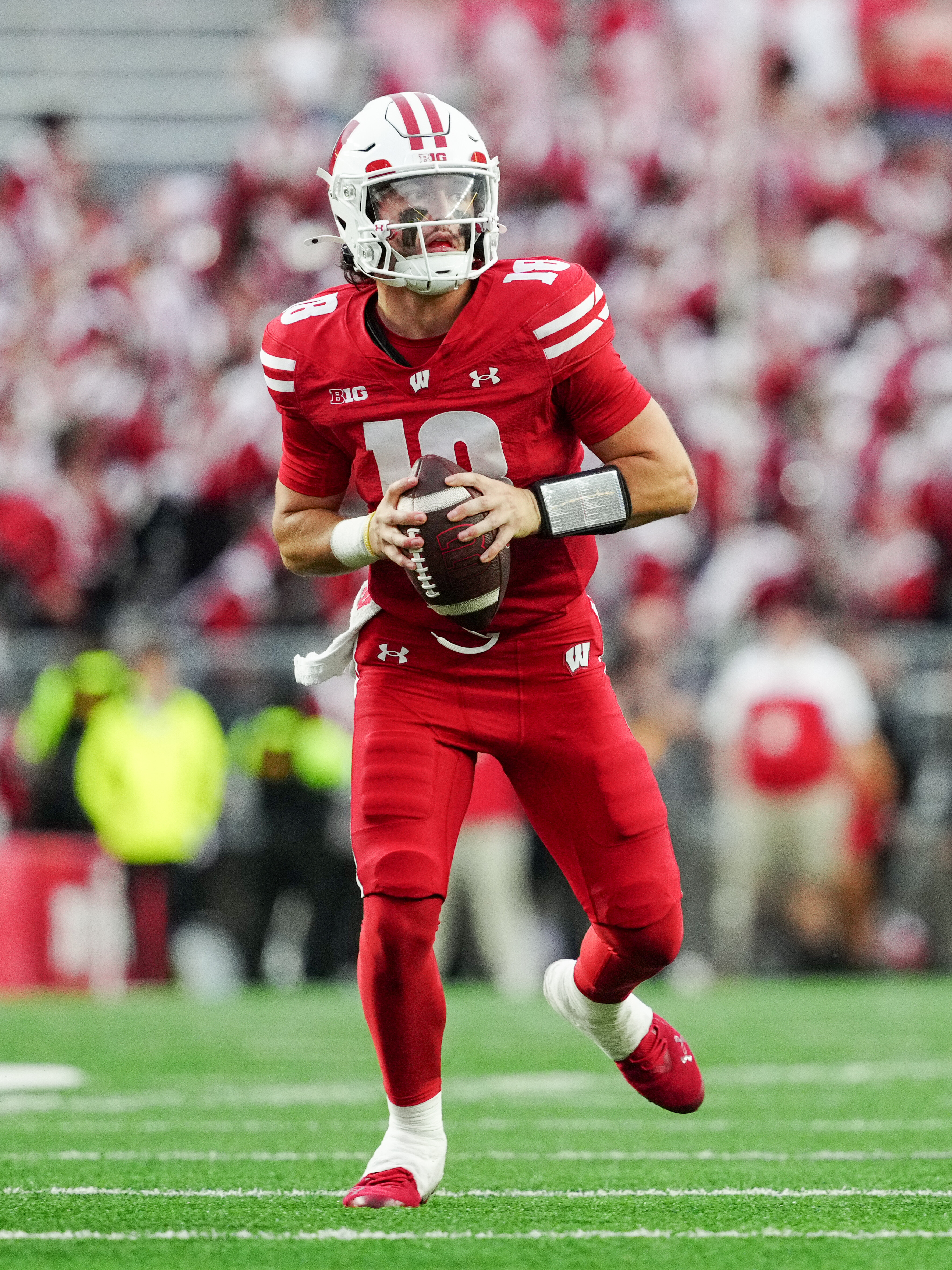 Oct 18, 2025; Madison, Wisconsin, USA; Wisconsin Badgers quarterback Danny O'Neil (18) looks to pass in the second half against the Ohio State Buckeyes at Camp Randall Stadium on October 18, 2025 in Madison, Wisconsin. Photography by Ross Harried for Second Crop Sports.