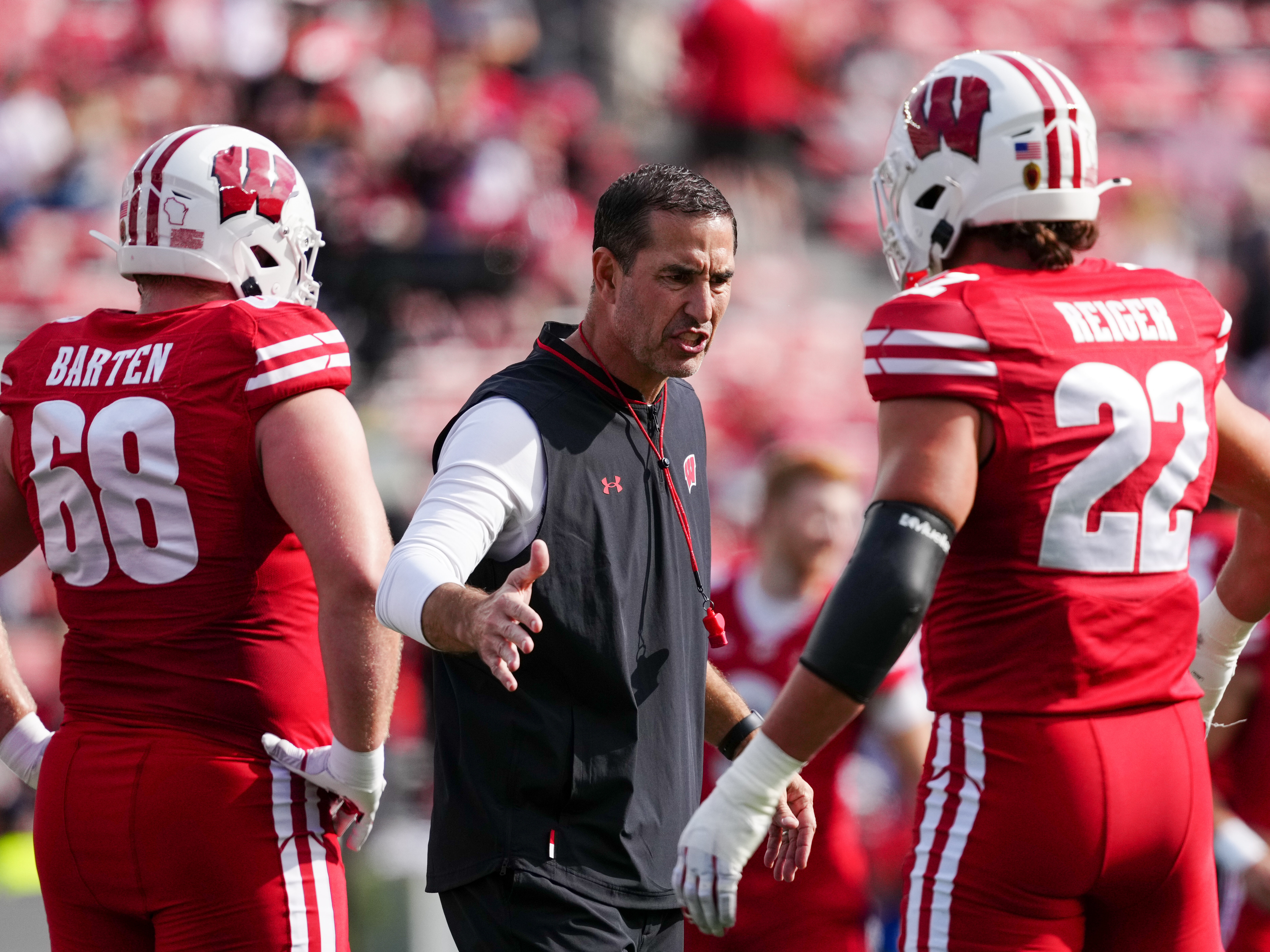 Oct 18, 2025; Madison, Wisconsin, USA; Wisconsin Badgers head coach Luke Fickell shakes hands with outside linebacker Mason Reiger (22) before a college football game between the Wisconsin Badgers and the Ohio State Buckeyes at Camp Randall Stadium on October 18, 2025 in Madison, Wisconsin. Photography by Ross Harried for Second Crop Sports.